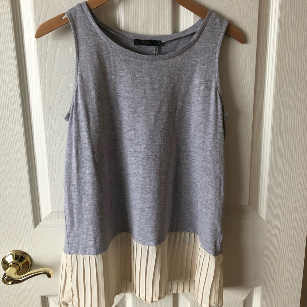 Gray tank top with cream colored fringe on bottom.